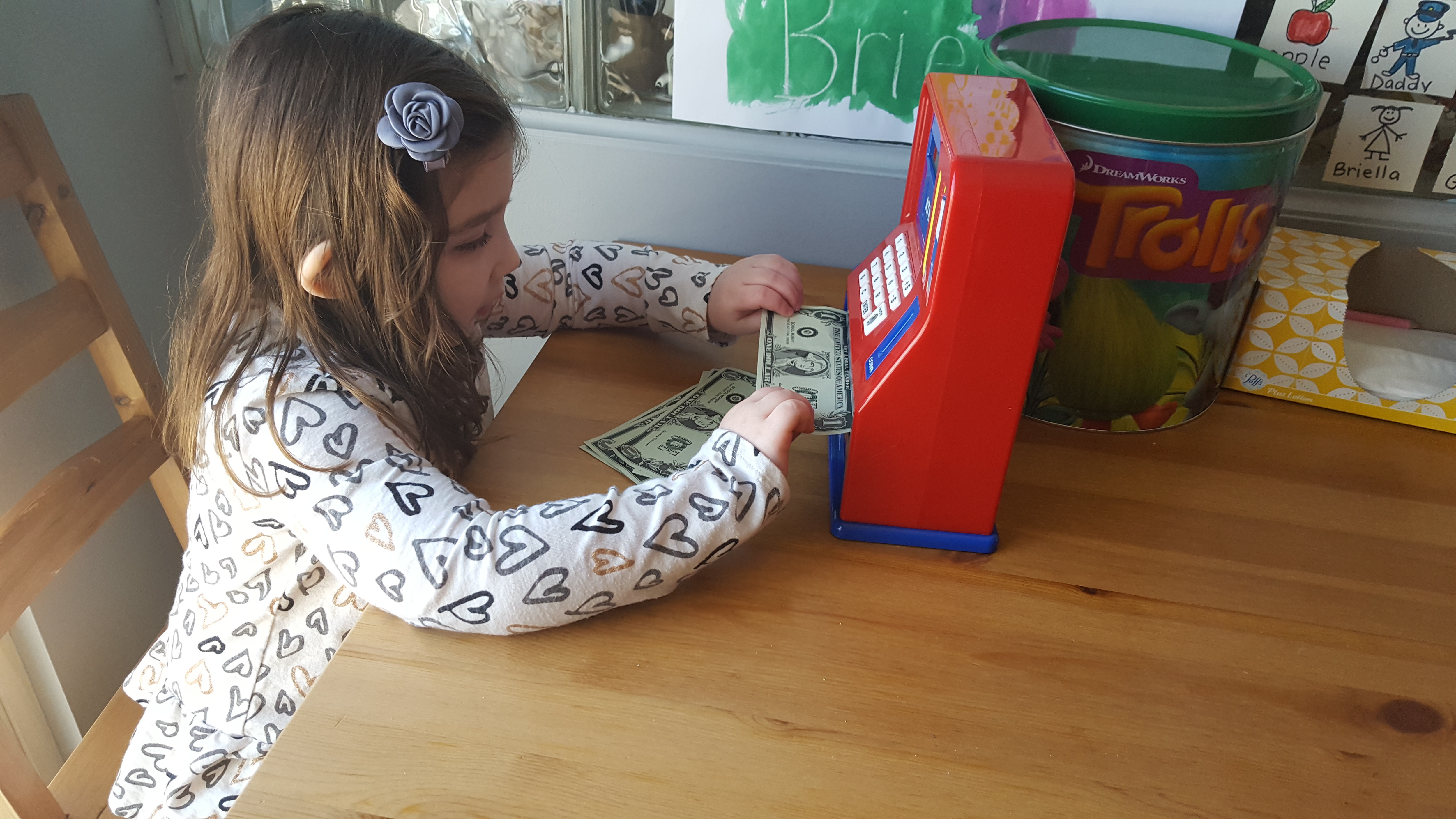 4.5 year old practicing her counting and names of coins