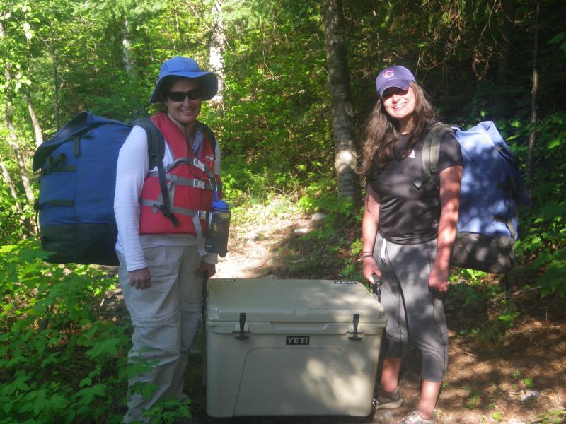 Wife and daughter portaging Yeti