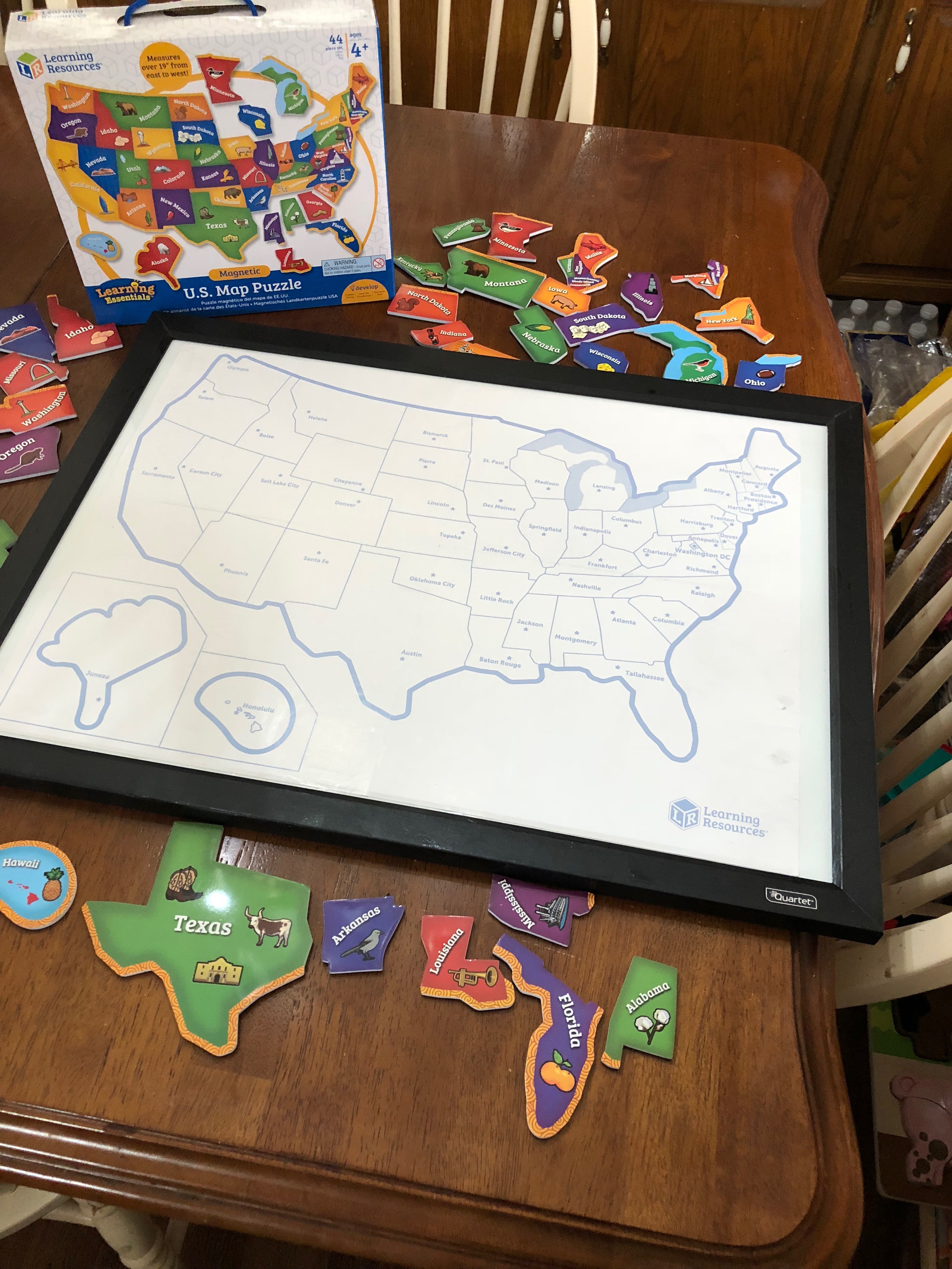 Used modge podge glue on magnetic dry erase board and smoothed out all wrinkles and bubbles!