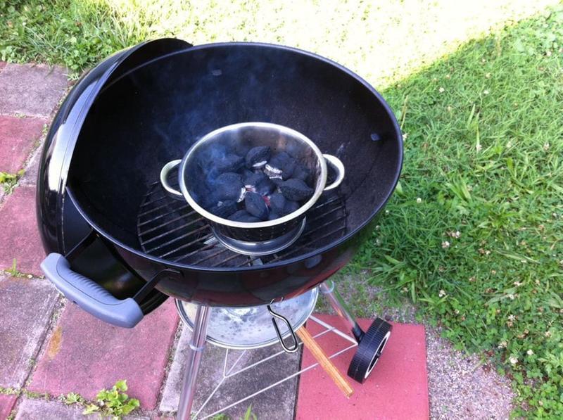 Preheating coals in a stainless strainer.