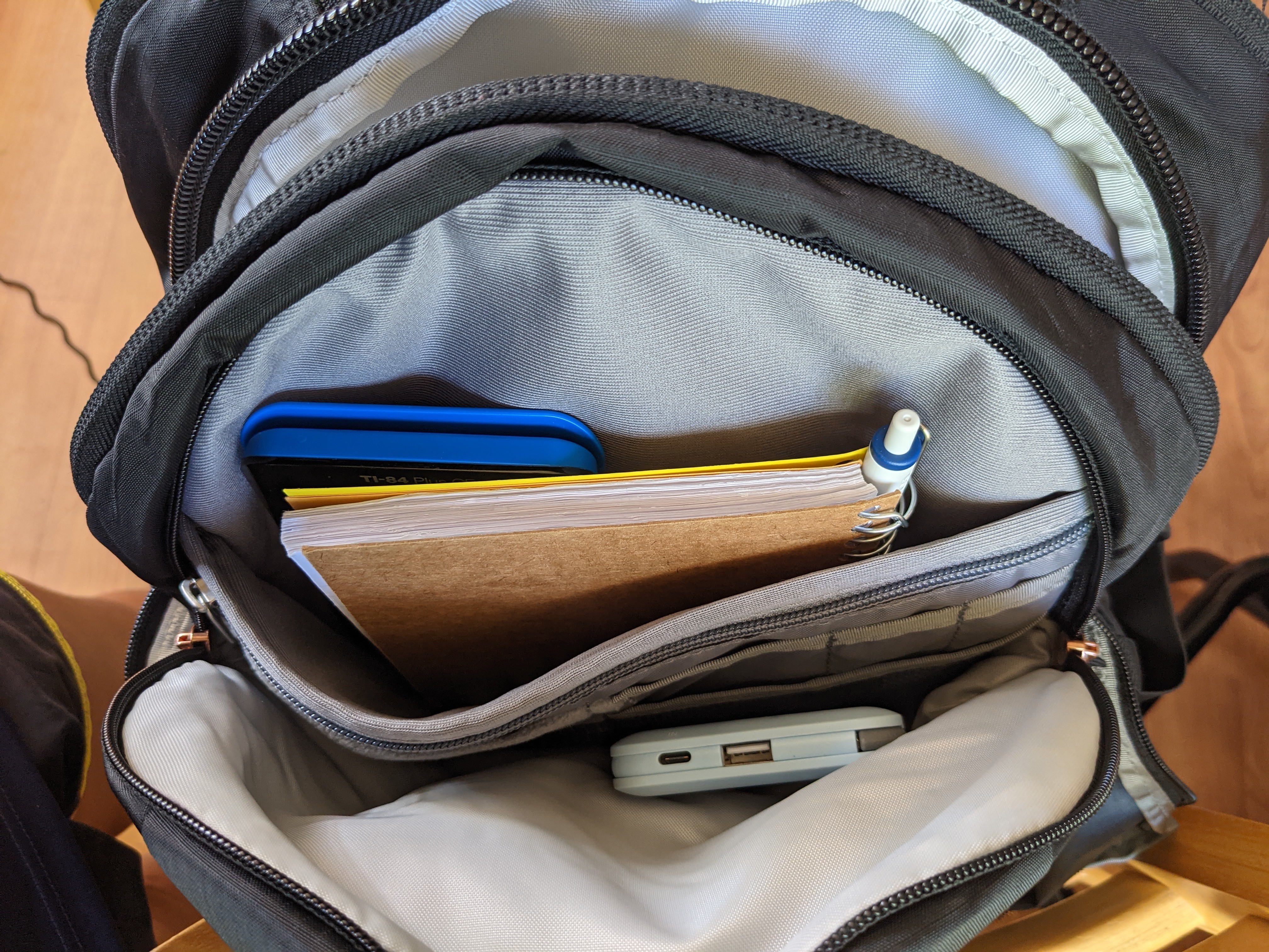 medium size compartment located in front of main compartment and behind fleece-lined pocket