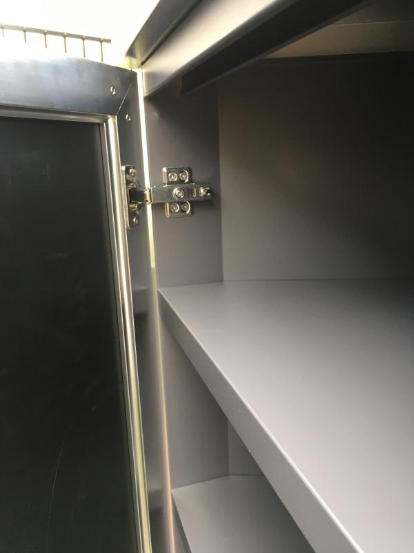 No opening for bolt to connect to grill insert.  If it was another cabinet next to it you could go through other cabinet but, not in the grill insert.