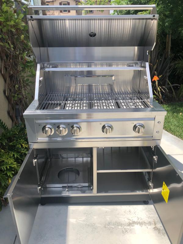 Grill with cabinet doors open