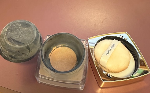 Black up that holds the puff is hinged and is open in this photo.  Mesh screen at the bottom of the cup.