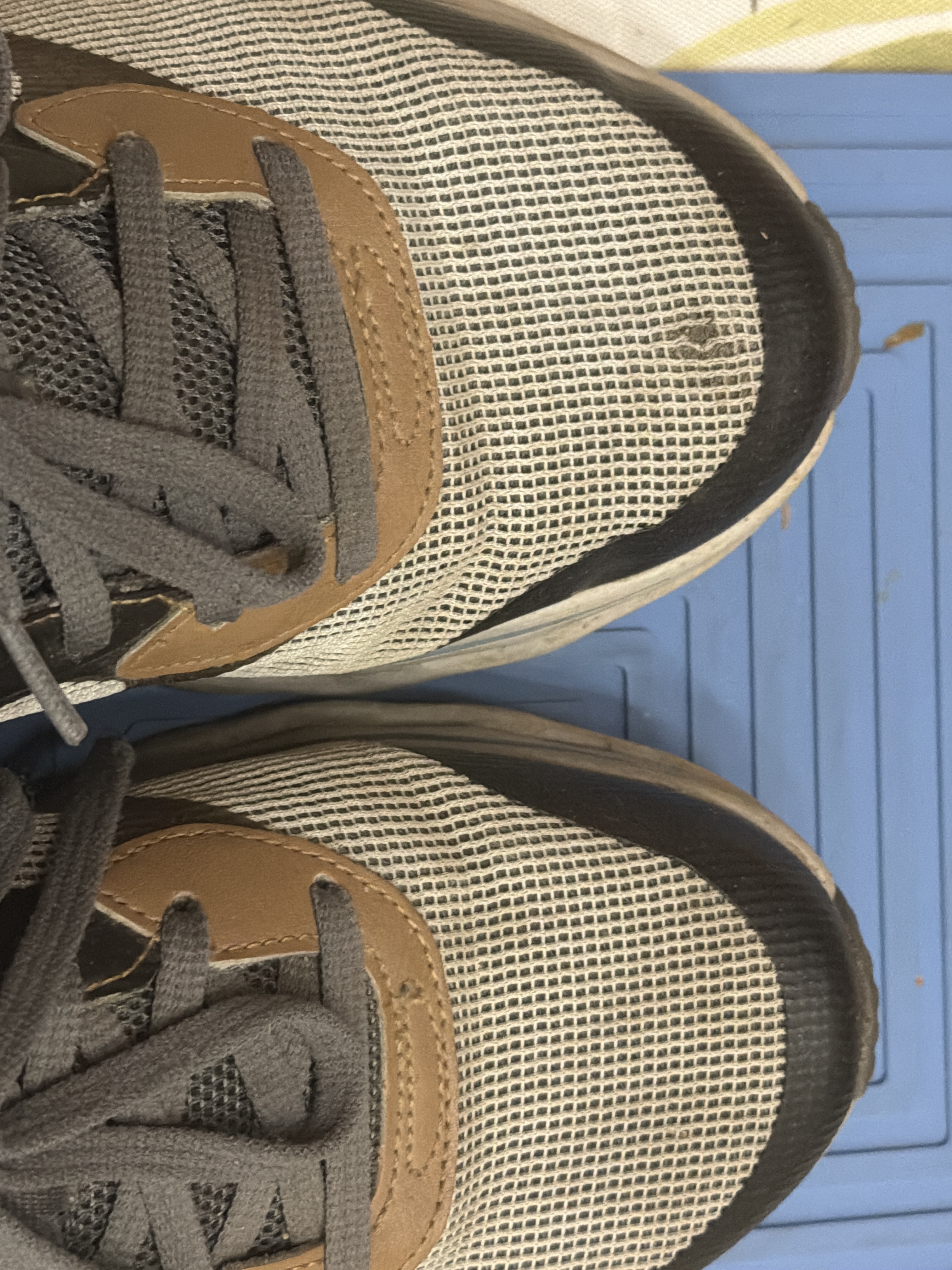 Left shoe toe wearing through.