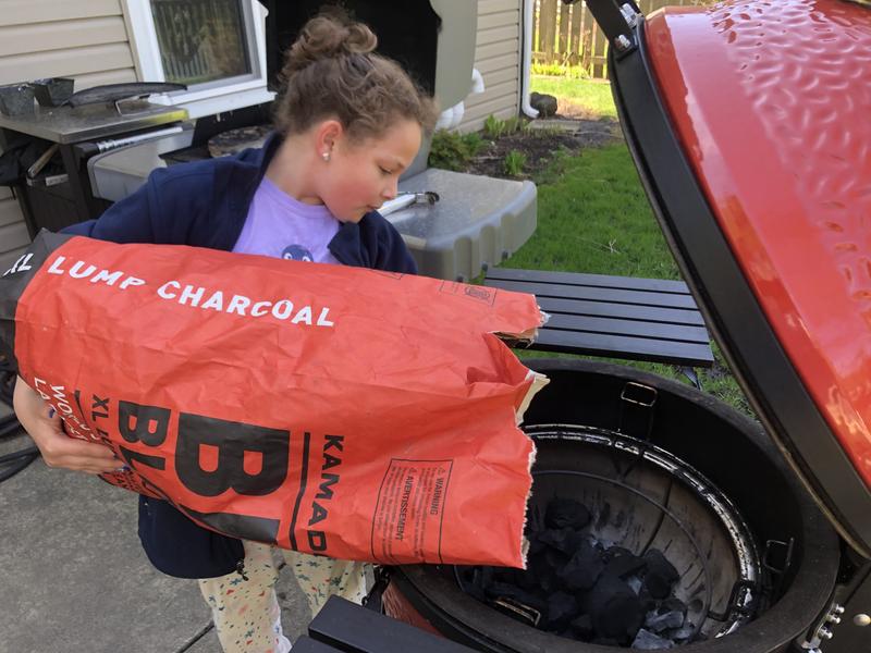 My grill buddy helping with filling the Kamado Joe!