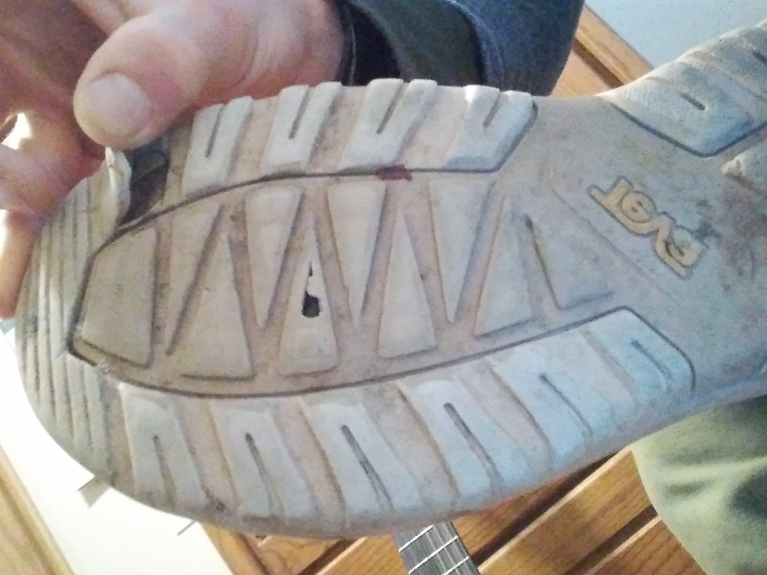 Notice the small hole in hallow tread design, as well as the tear near my thumb....