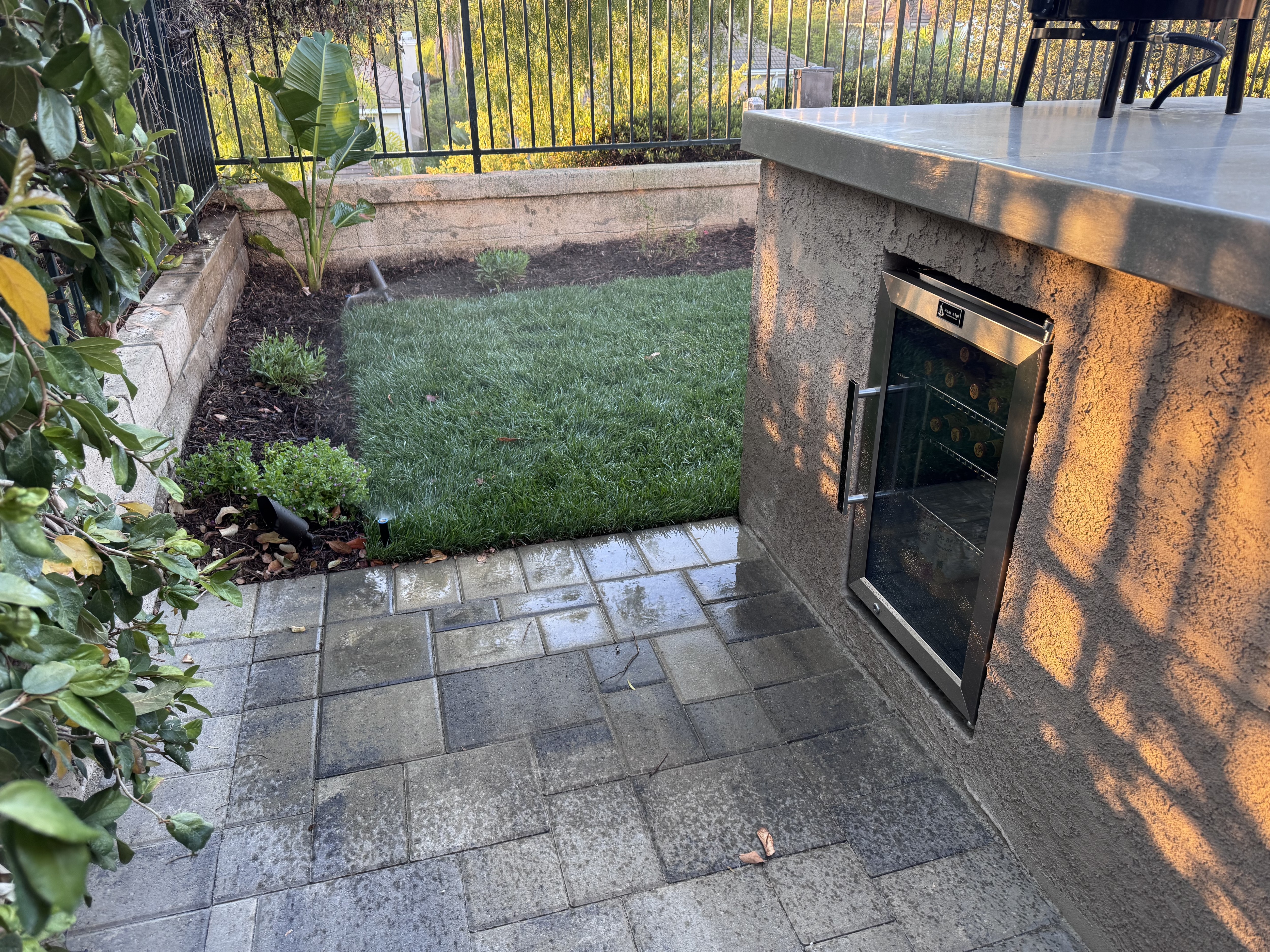 Built into the outdoor kitchen like a tiny stainless steel panic room dedicated entirely to ice-cold drinks and poor impulse control.
