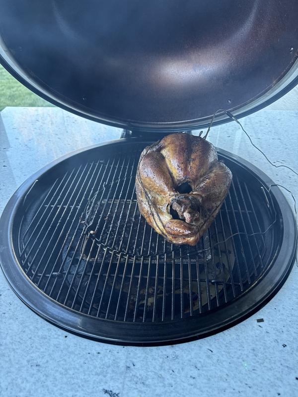 Full size trussed turkey on grill for smoking