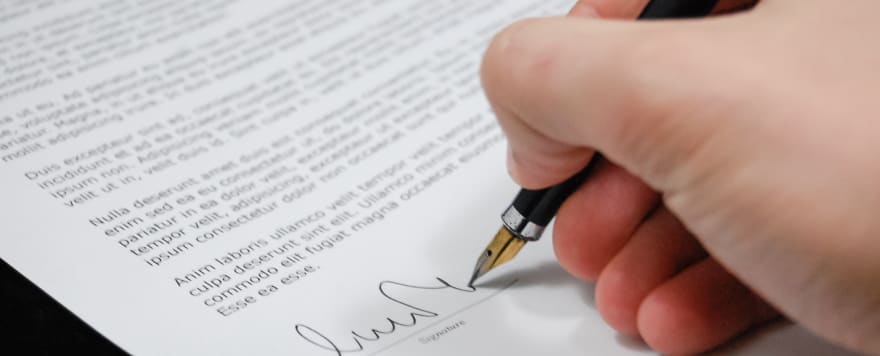 Image of hand signing a legal document