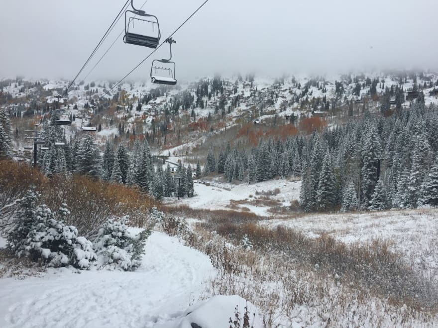 the first snow of the season with brush still showing on the main runs of Brighton ski area, Utah.