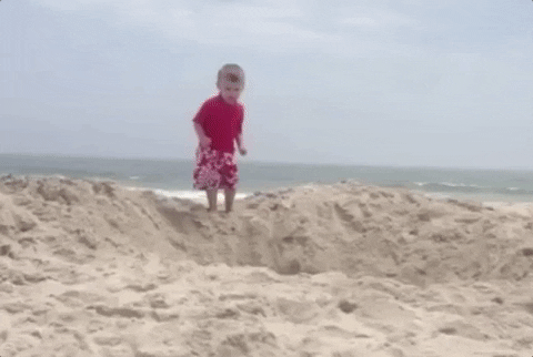 child makes small dive in sand beach