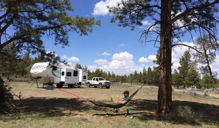 A photo of Jon McCartie, working on a hammock in California