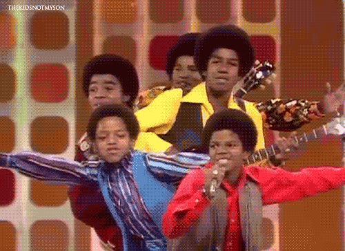 The Jackson 5 performing live and posing together for a dance move.
