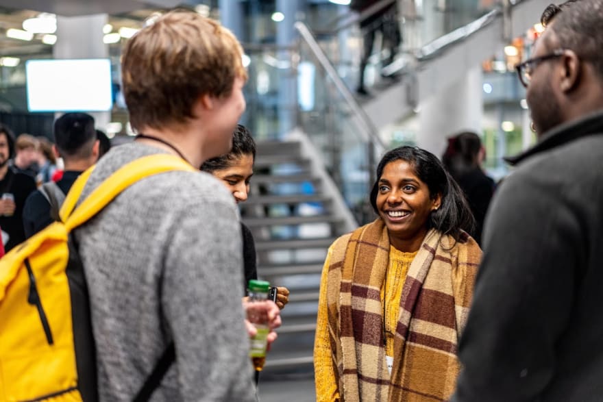 Four people talking in a group during one of the networking breaks
