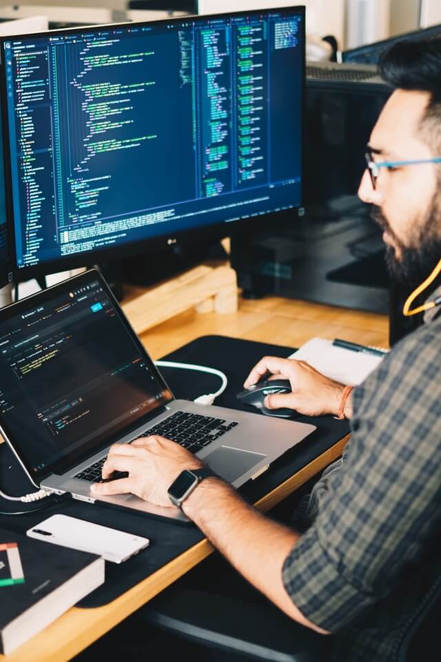 bearded man sitting at laptop computer