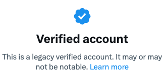 Our blue check with the text "Verified Account: This is a legacy verified account. It may or may not be notable."
