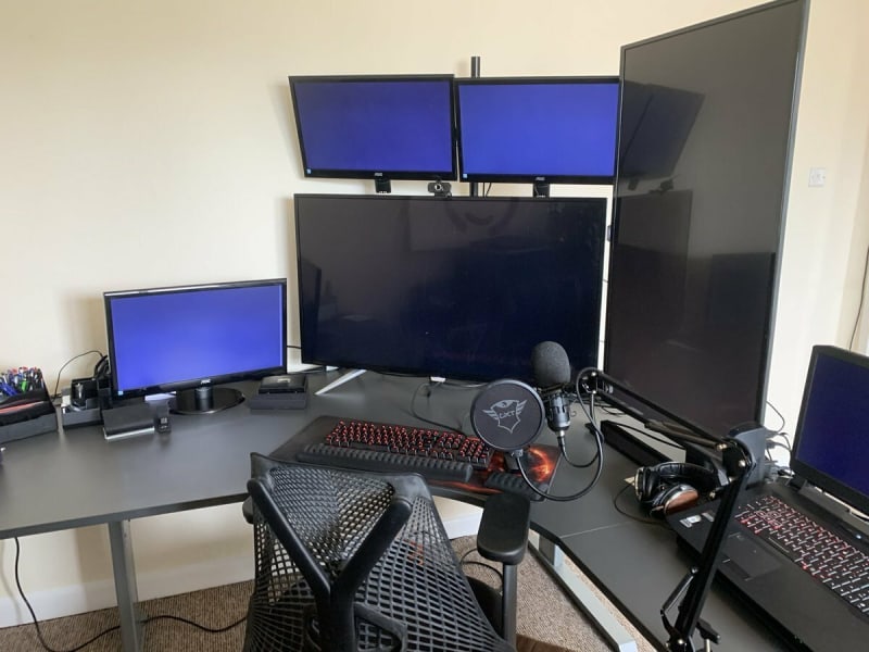 computer with 2 43 inch screens, one vertical and 3 21 inch screens plus a laptop screen.