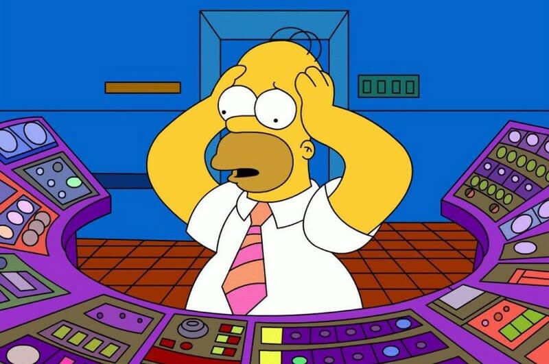 Homer Simpsons is scratching his head, surrounded by dozens of buttons around him