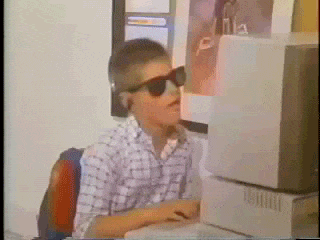 A kid on a computer jamming out to music and typing