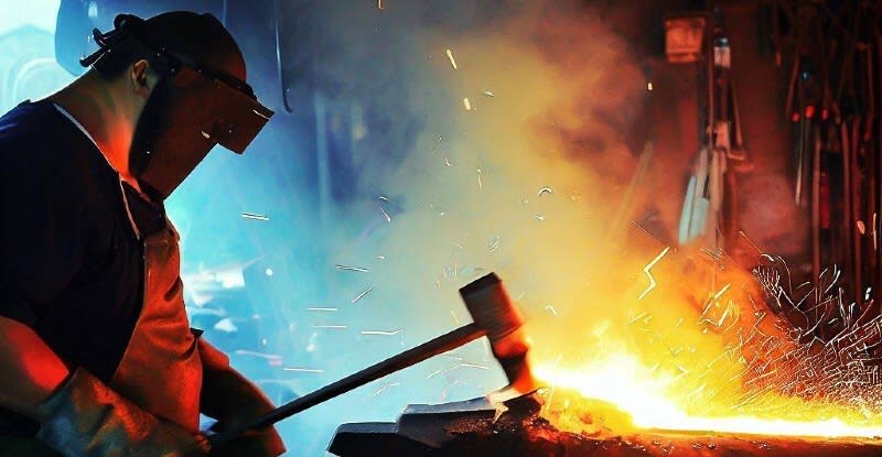 father working as blacksmith