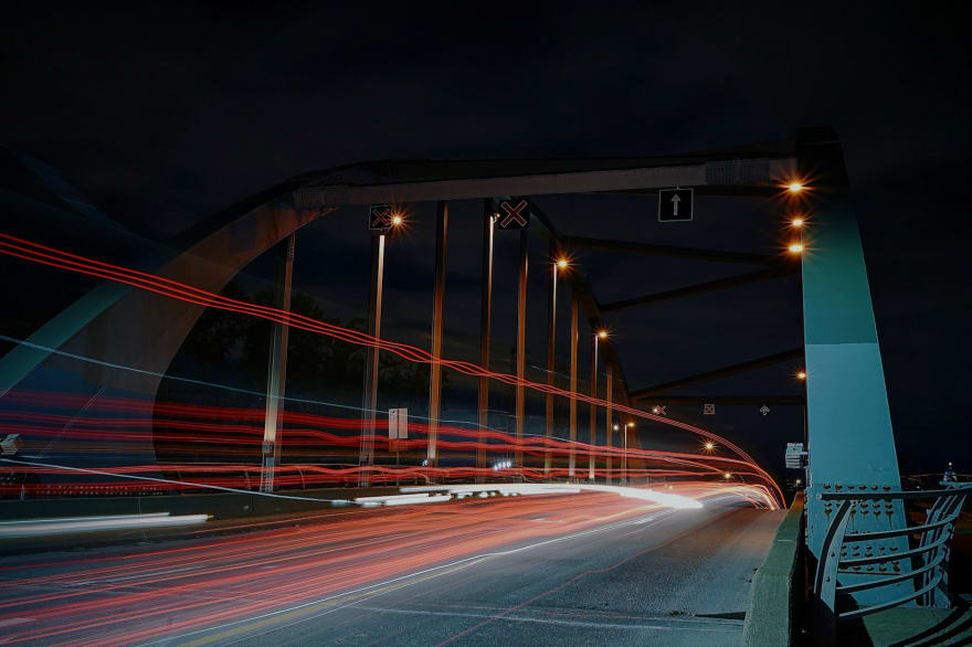 night view of cars on a bridge