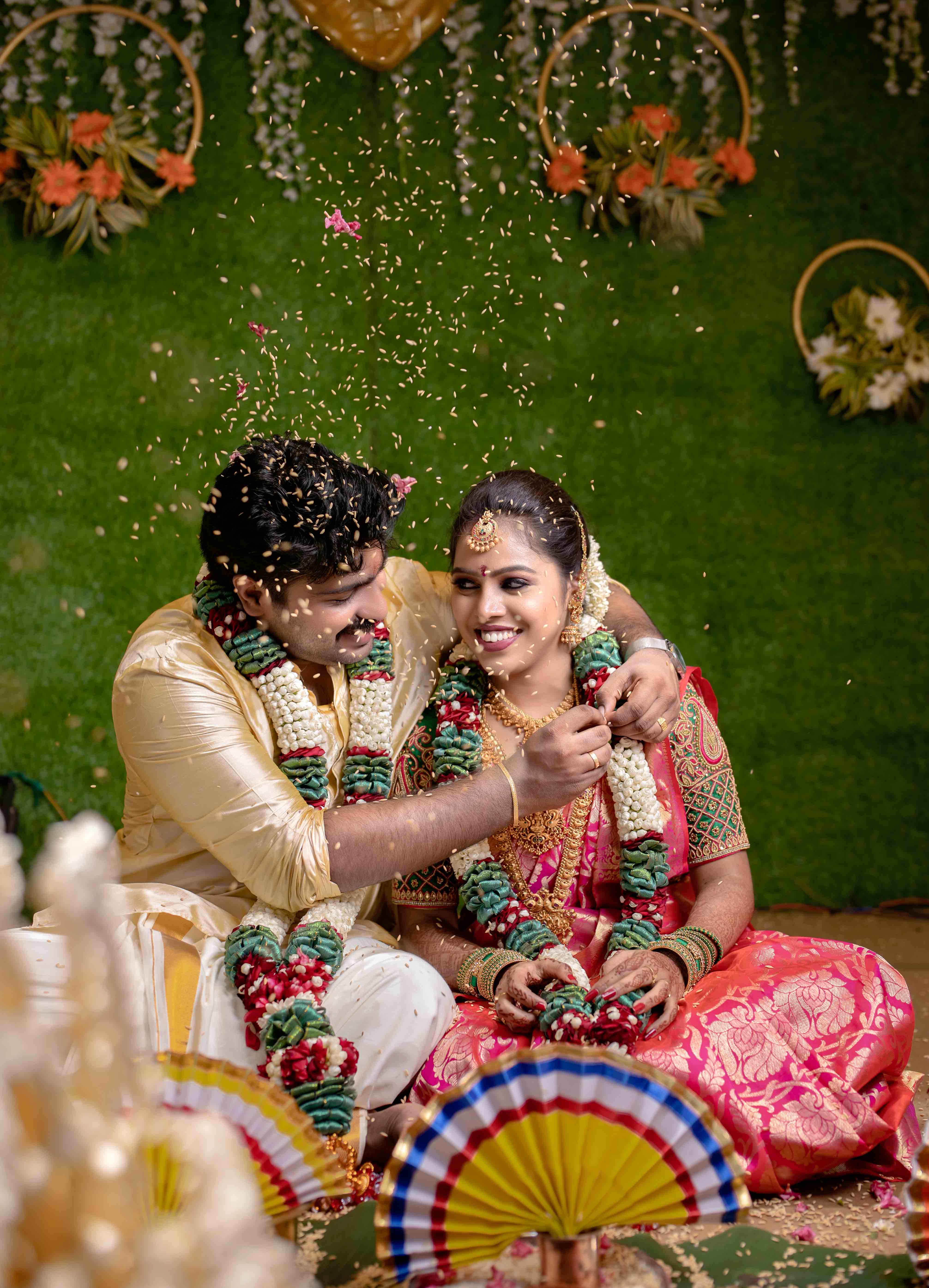 Professional wedding photographer capturing candid moments during Indian wedding ceremony