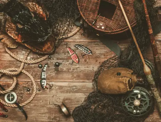 A photo of aged fishing tools on a wood table