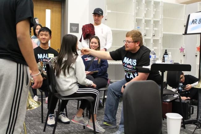 Band students helping younger students audition for band.