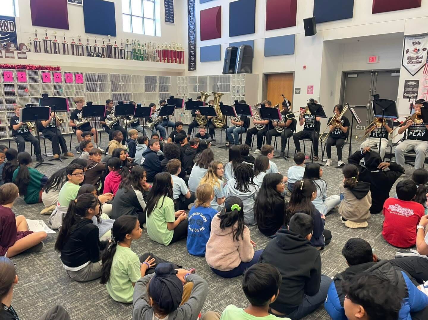 Band students performing for younger students.
