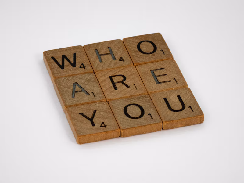 Game pieces that spell out "Who are you".