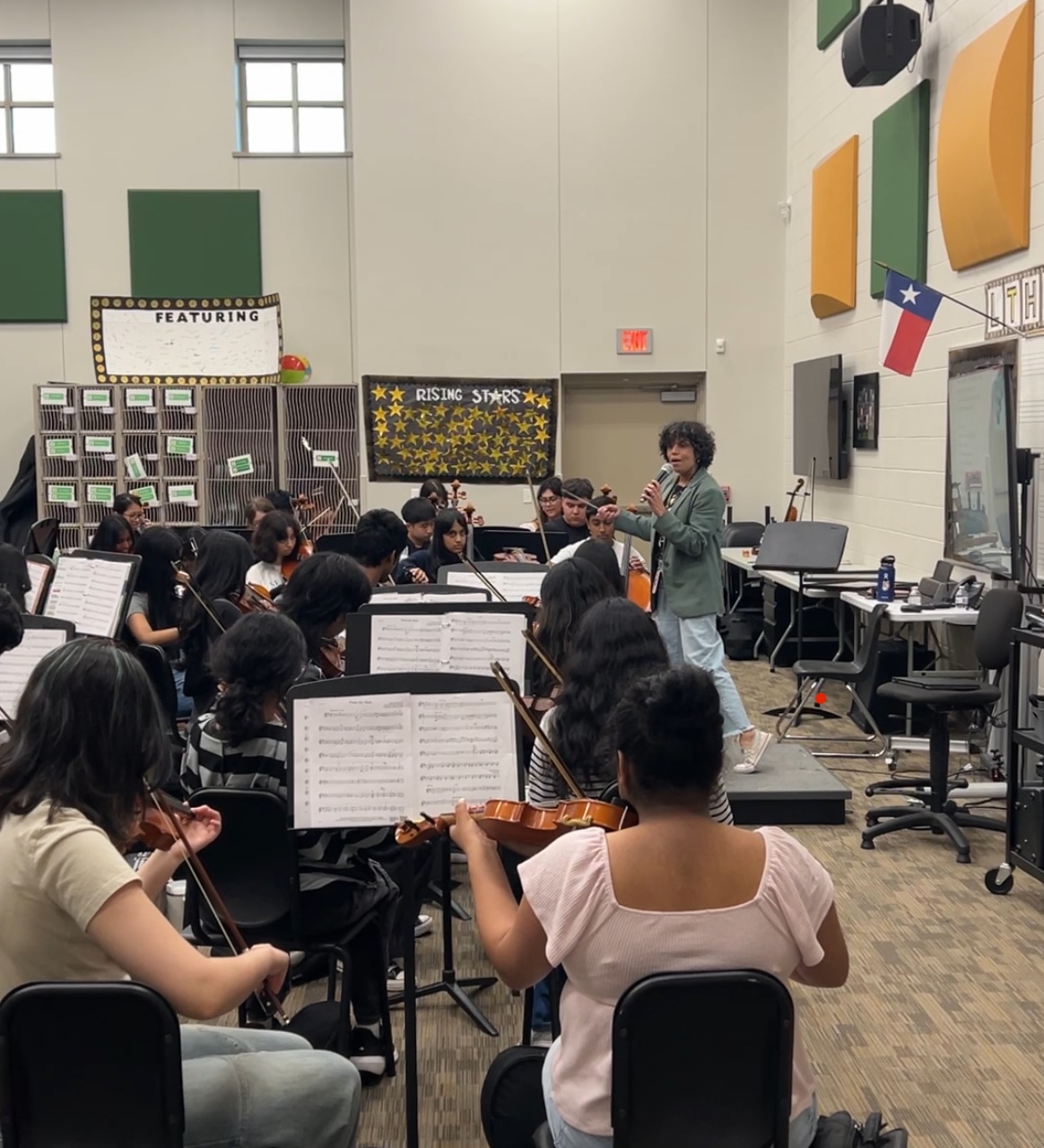 Aline Moore singing in her orchestra classroom.