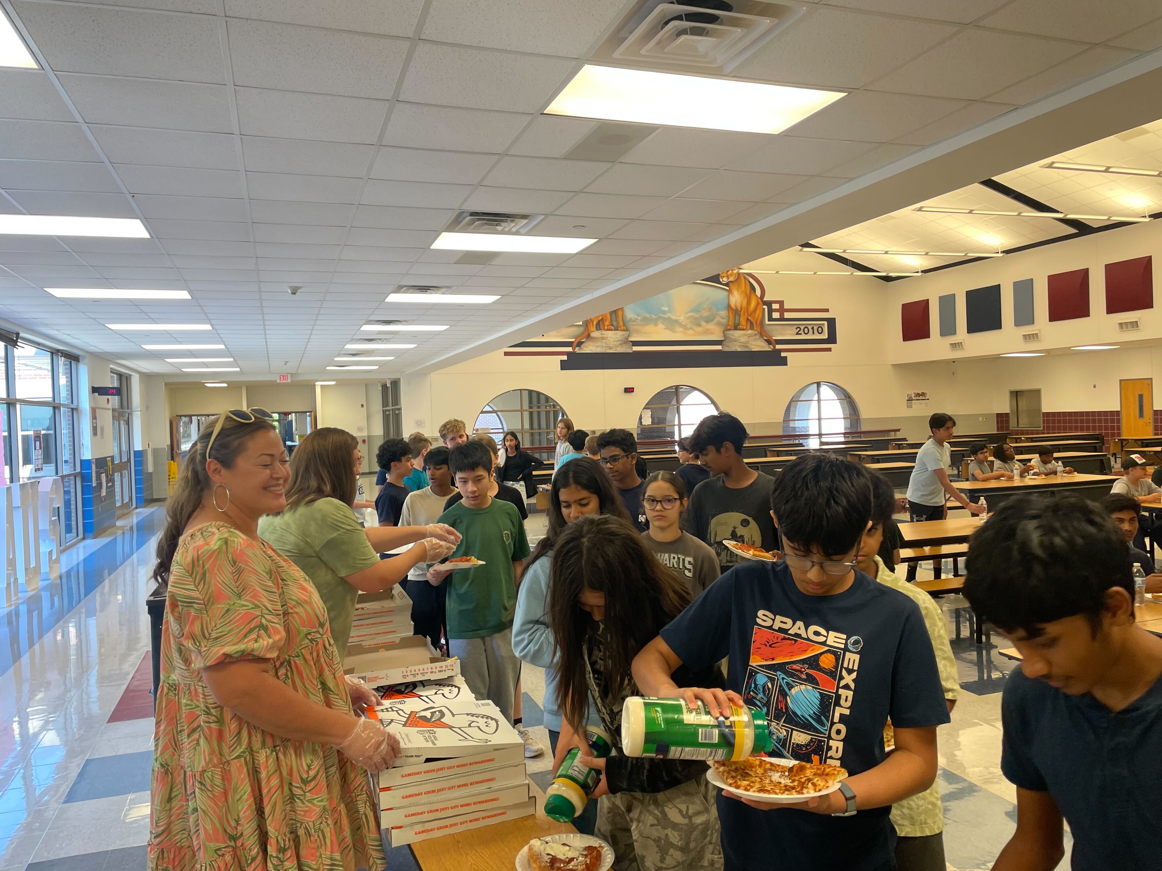 Students enjoying some pizza during a band event.