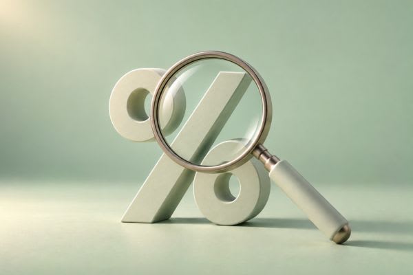 Symbole pourcentage sous une loupe pour illustrer le taux de rachat de crédit en 2026