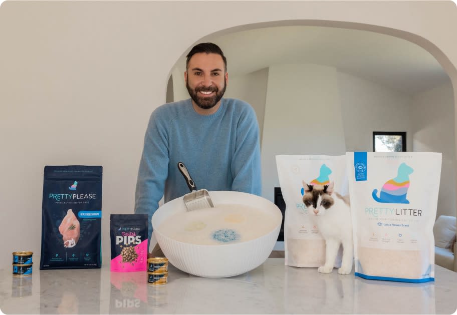 Daniel is standing in front of a counter with various PrettyLitter products