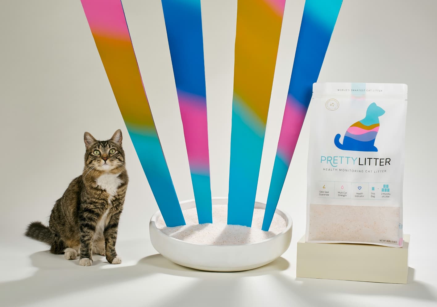 PrettyLitter bag and litter box with rainbow beams
