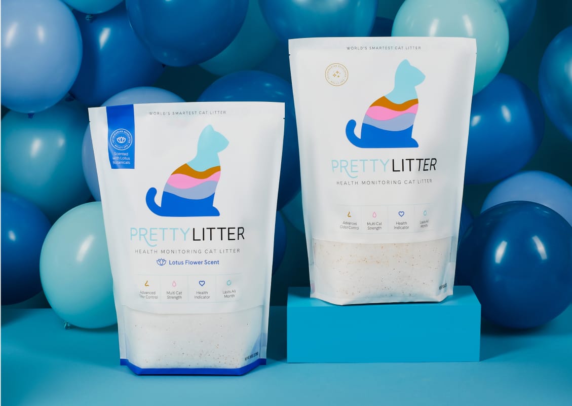 PrettyLitter package and bowl of litter with paw prints and scooper