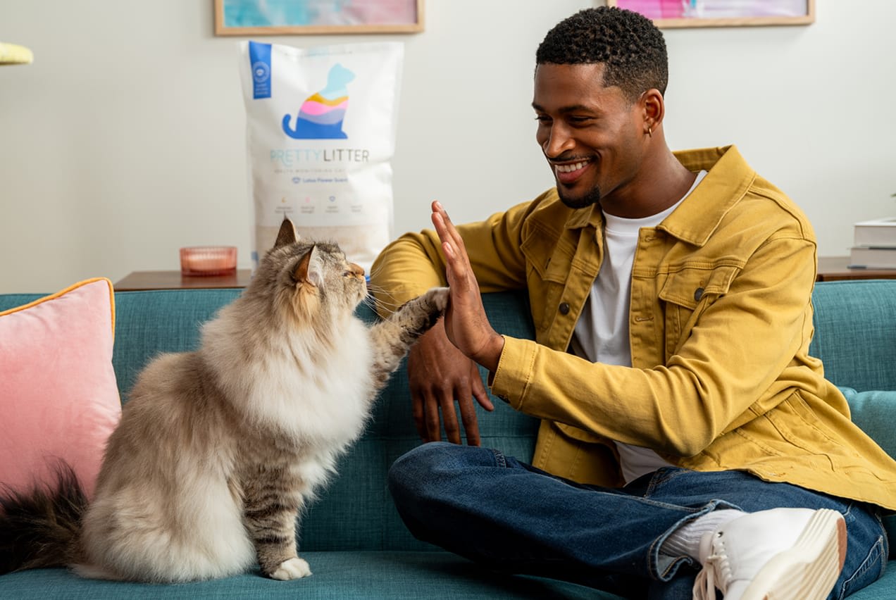 Man with cat and PrettyLitter product