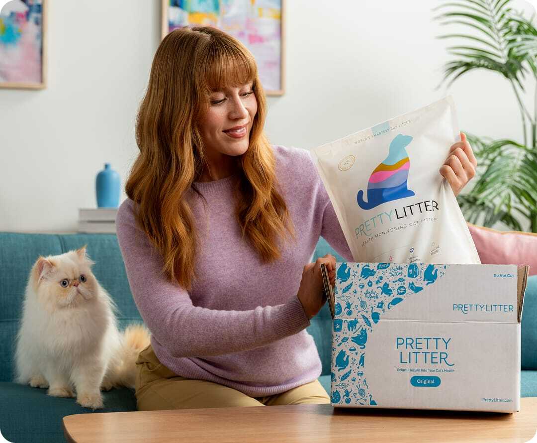 A women unpacking a bag of PrettyLitter from a box