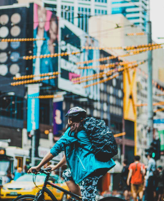 Person riding a bike through the CBD