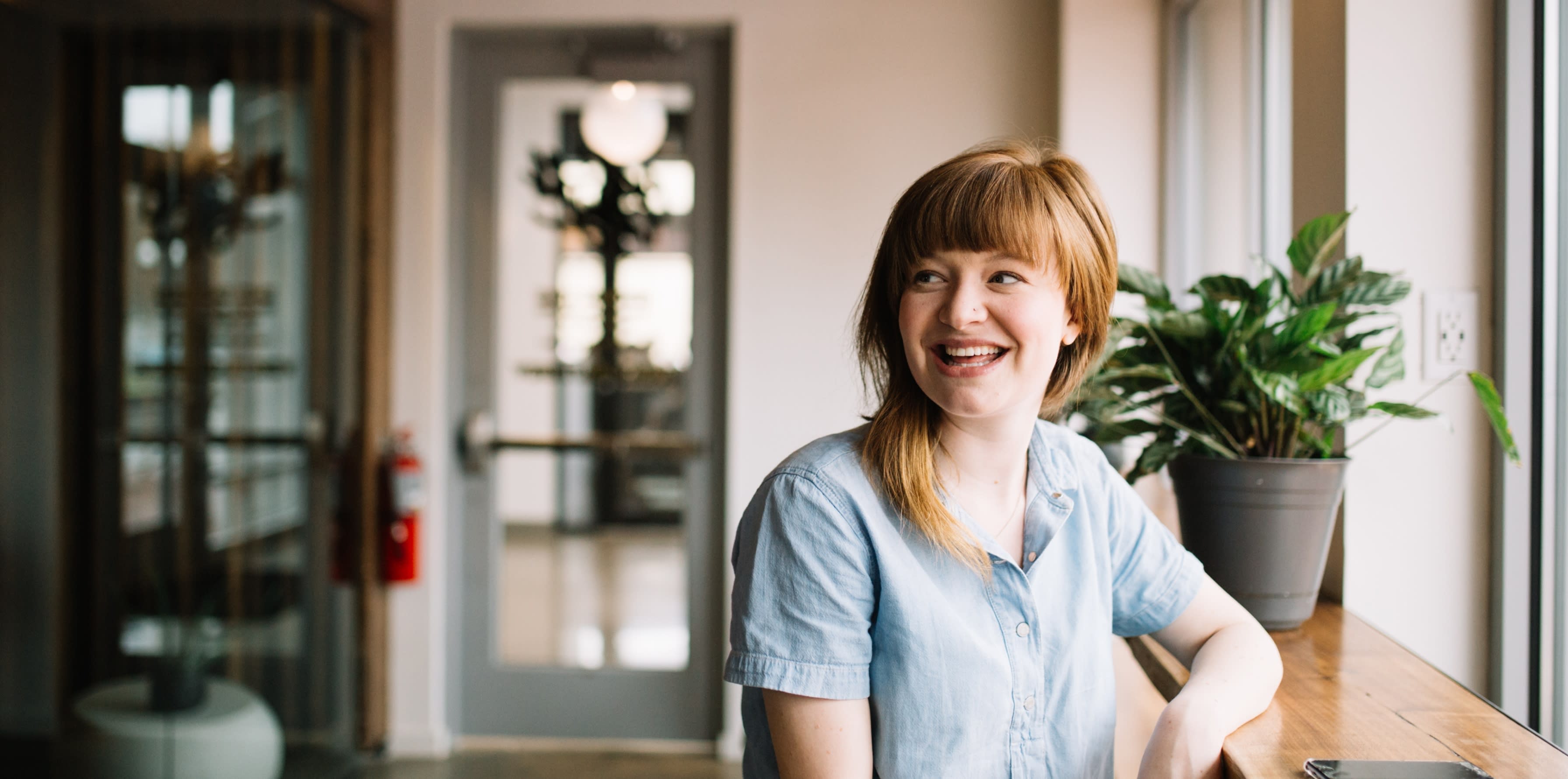 Woman sitting at a bench indoors