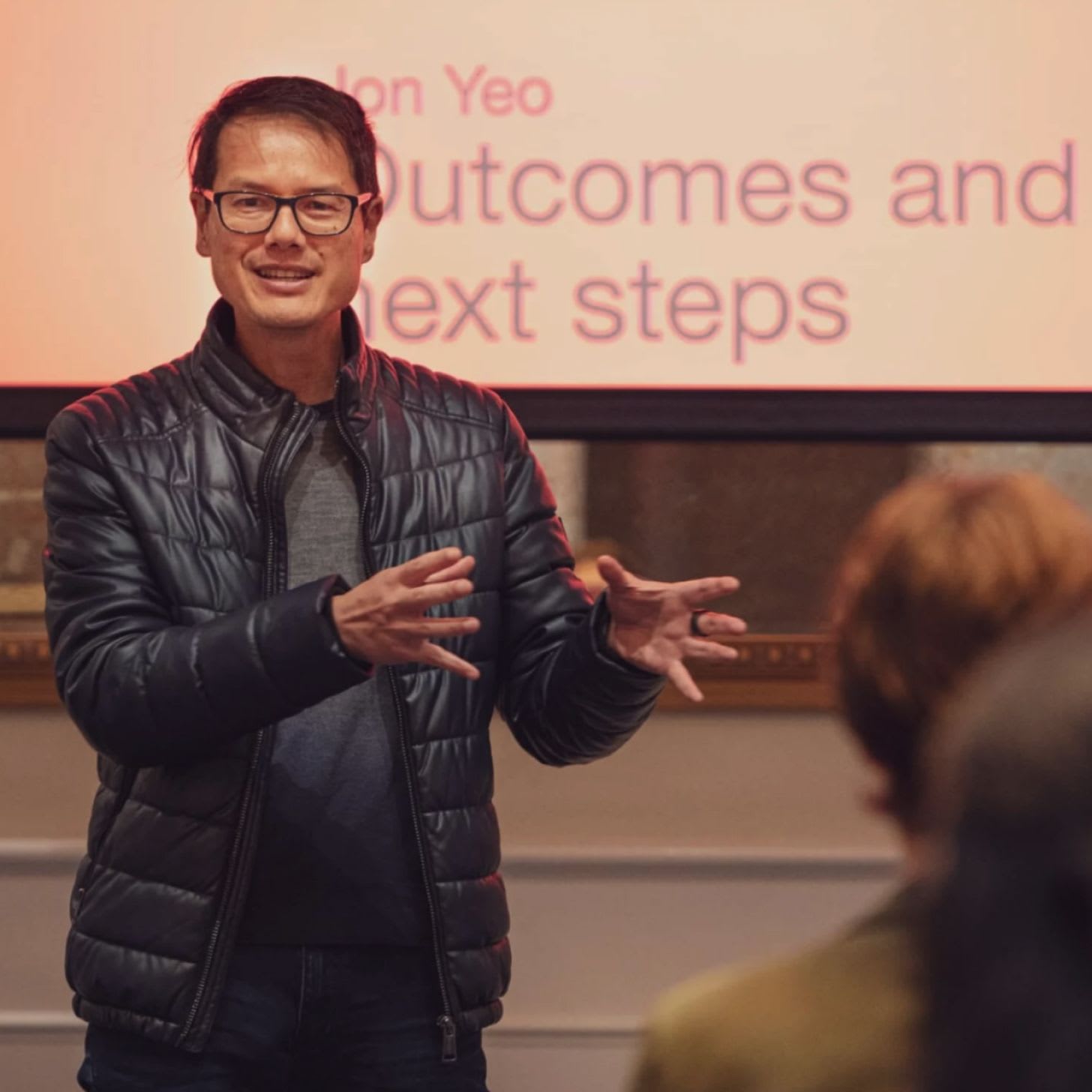 A speaker talking to a group of people