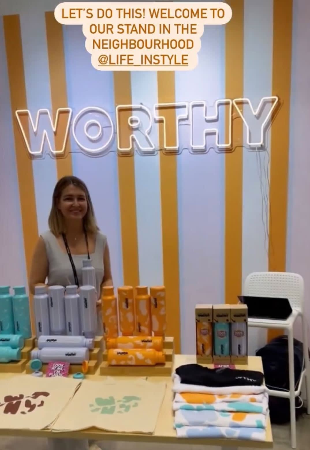a woman is standing in front of a display of products.