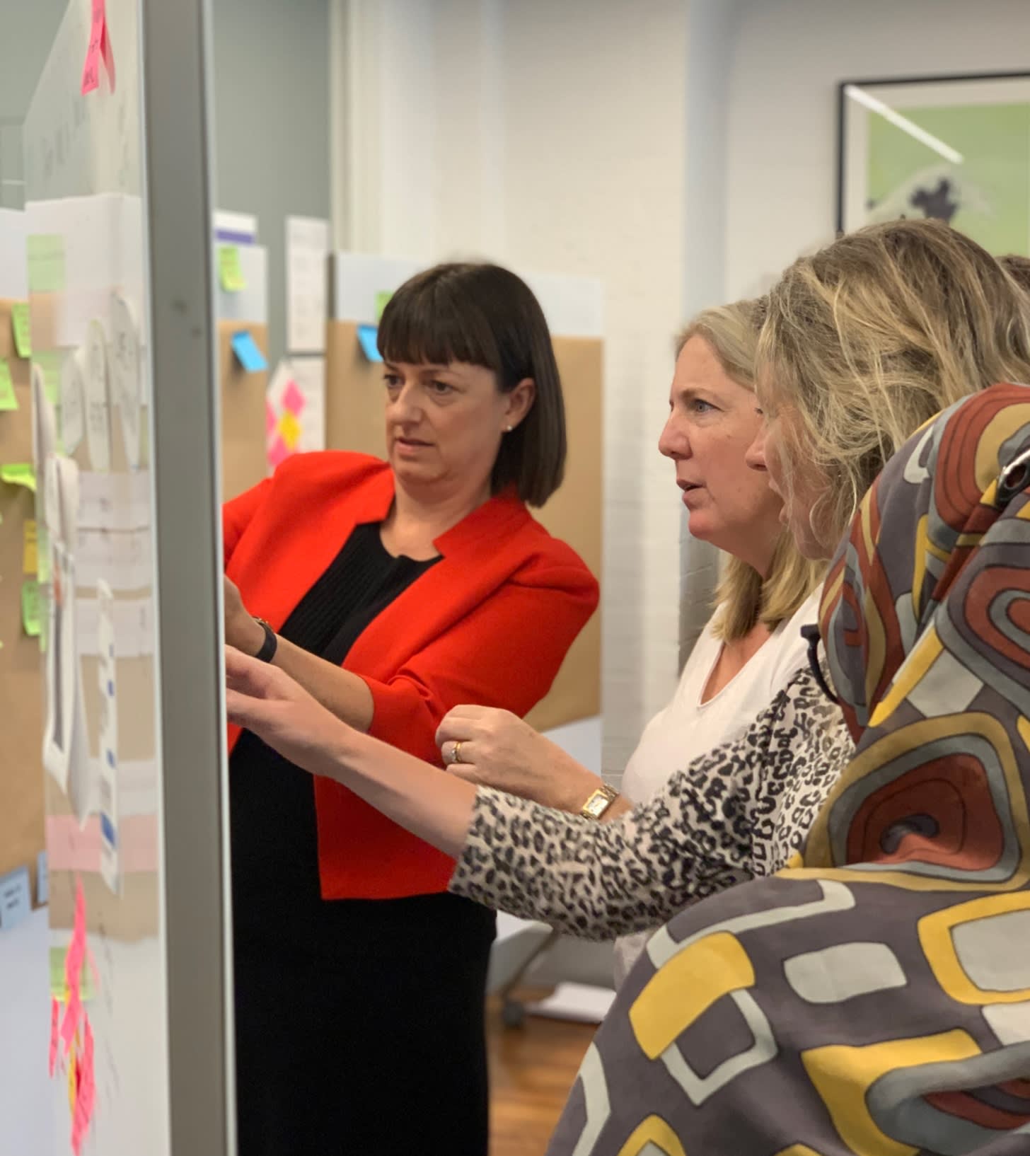 People discussing in front of a board