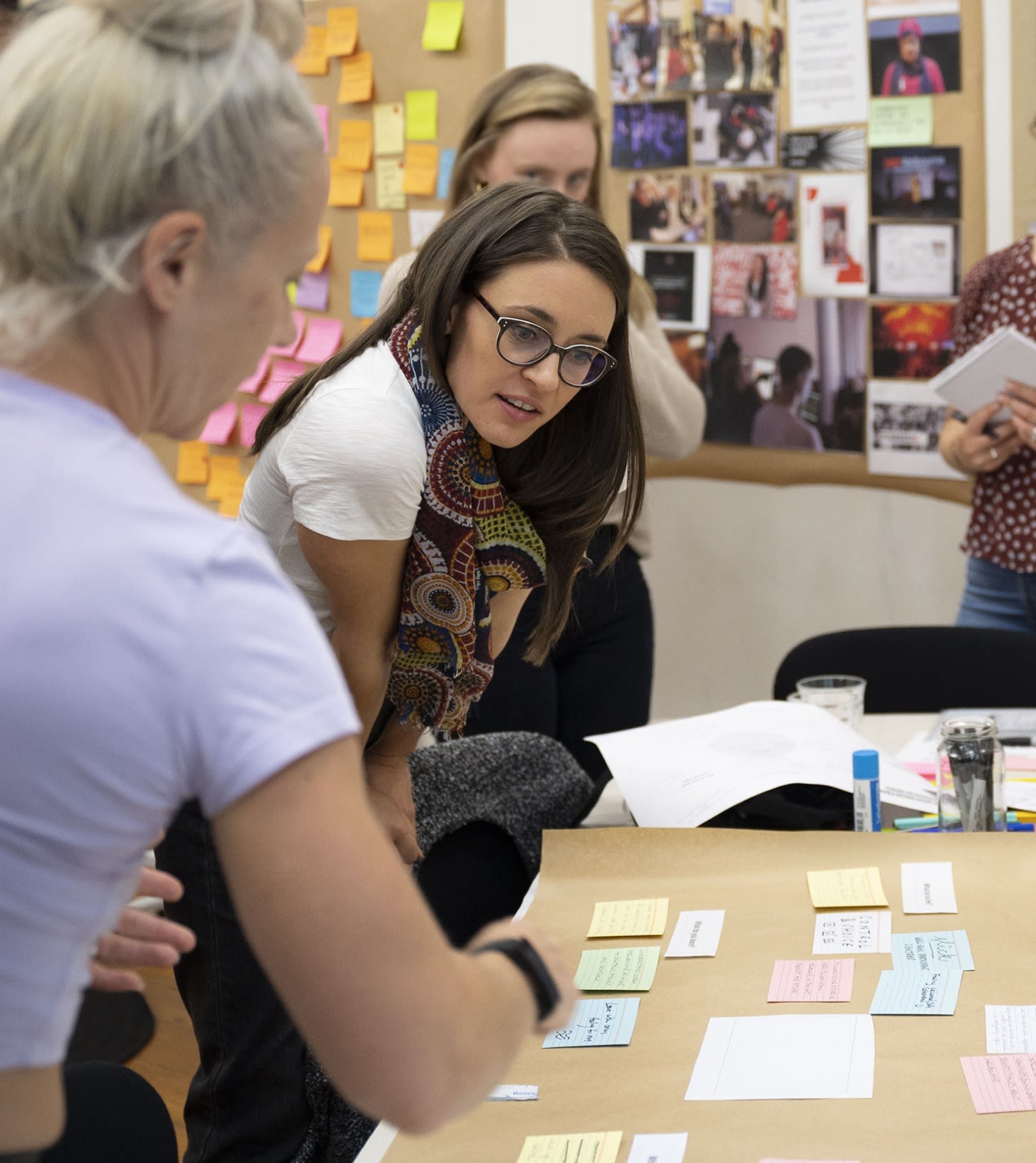 A group of people discussing around a table of placecards