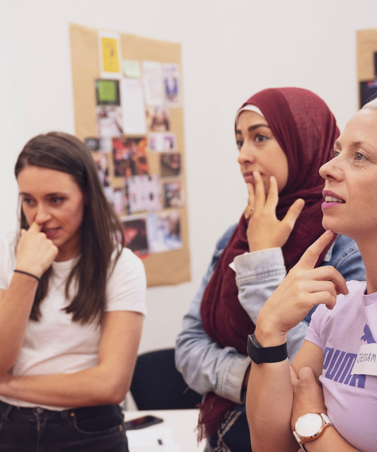 Three women thinking and ideating at a workshop