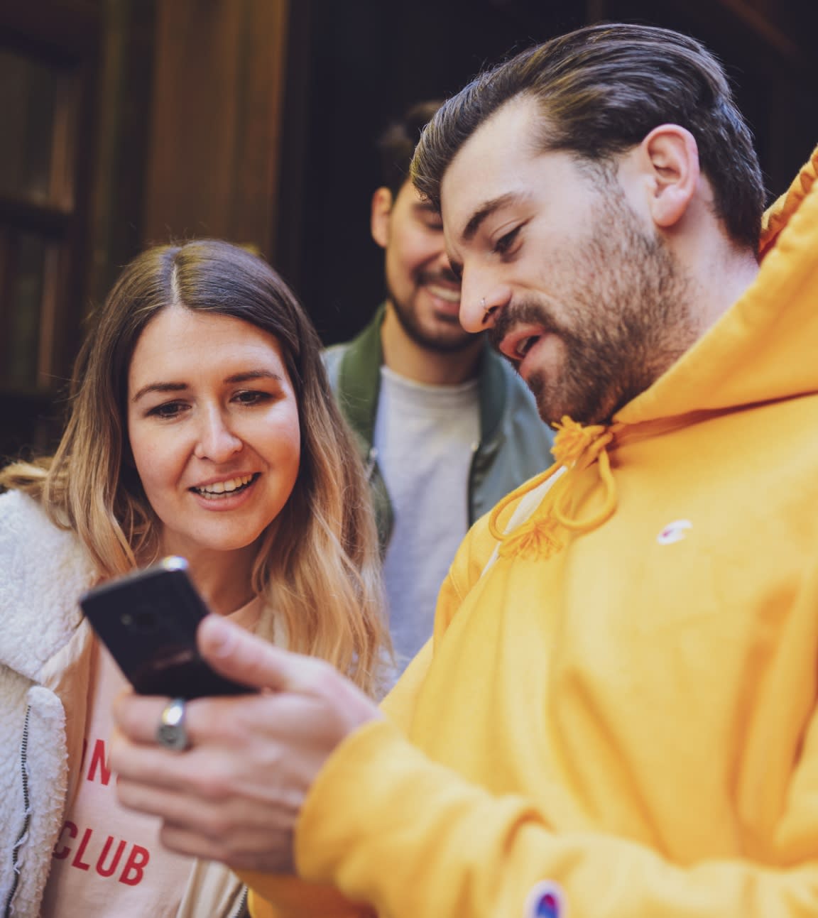 Person showing their phone screen to others