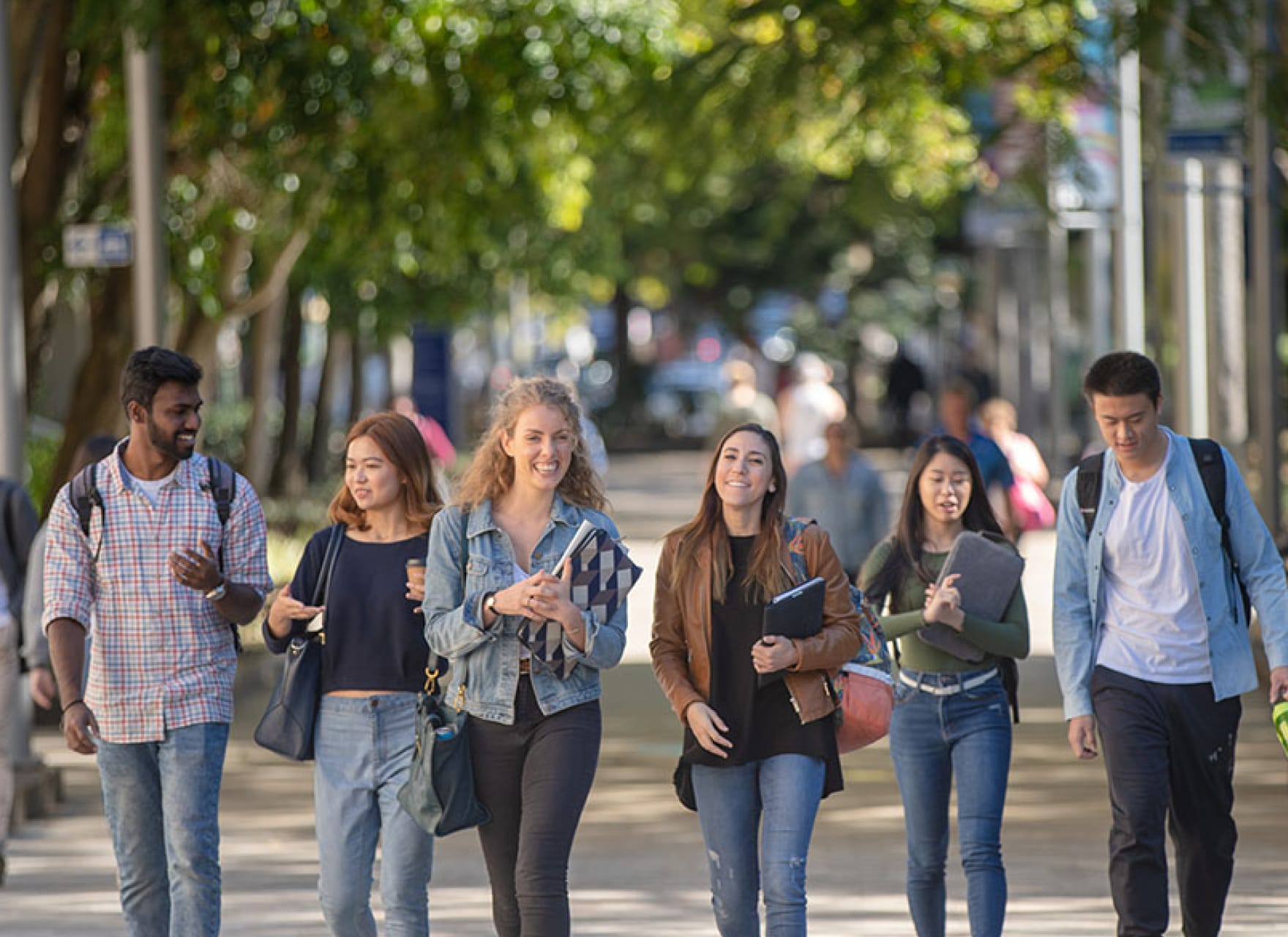 Six young students walking together outside