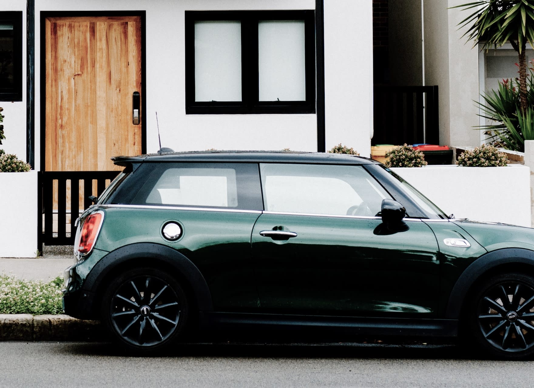 Green car parked in-front of house