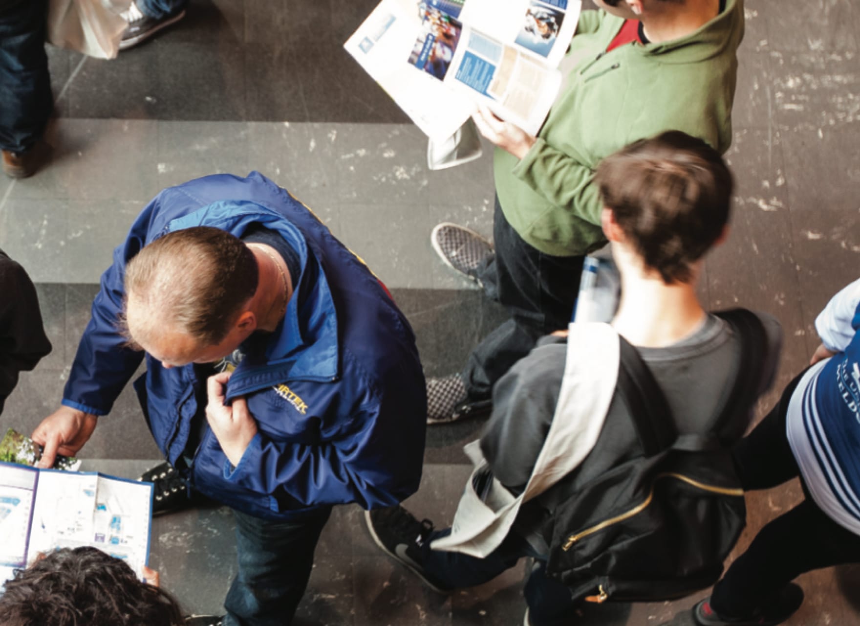 Birds eye view of people walking past each other